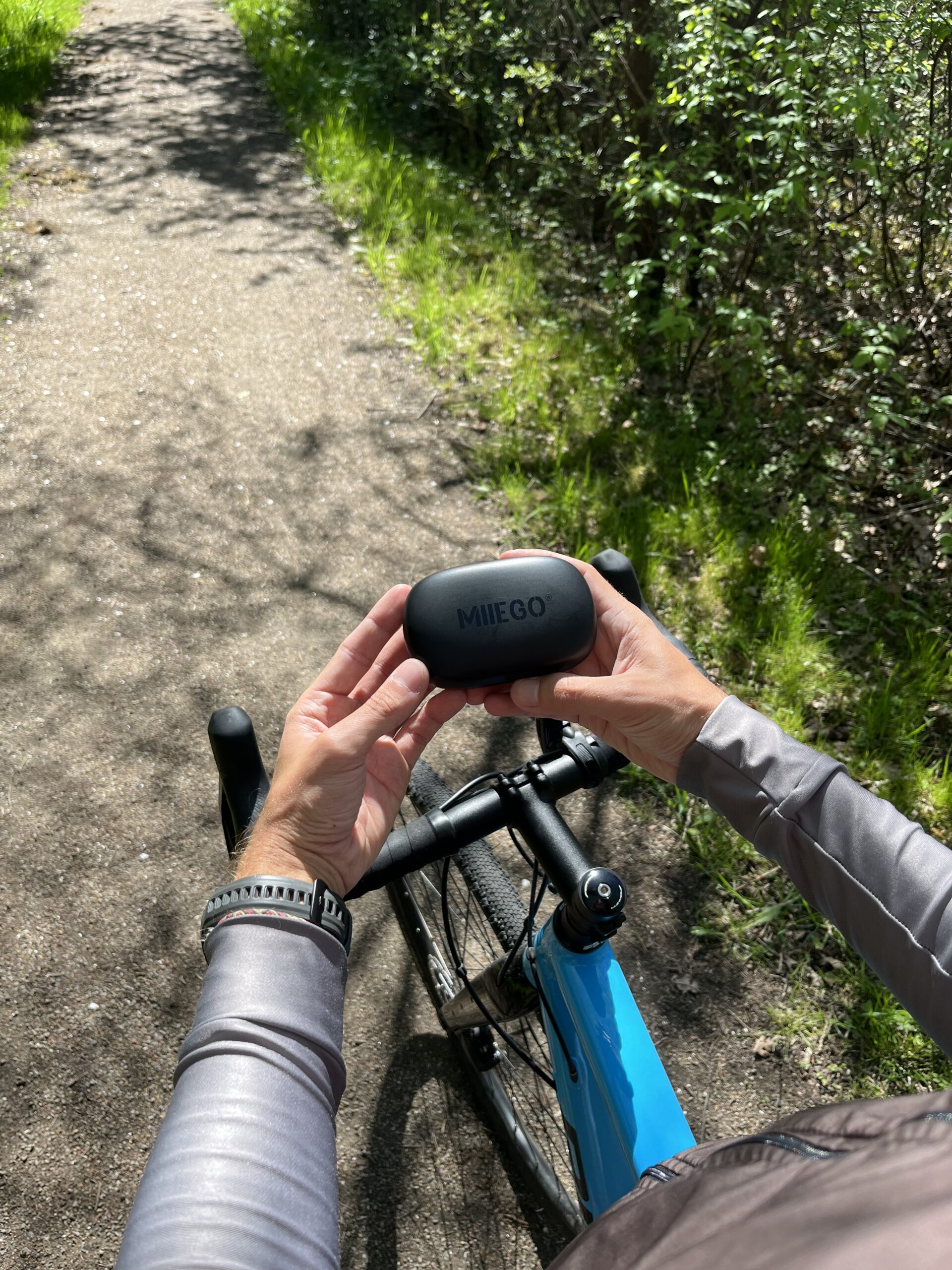 MIIEGO Miibuds Active GO høretelefoner - Sort - Ses i natur med gravel cykel - Lukket etui